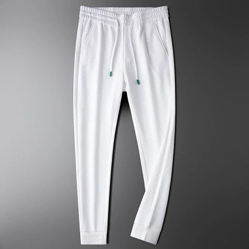 Versatile black unisex relaxed fit pants, ideal for everyday casual wear & loungewear. Modern, comfortable style.