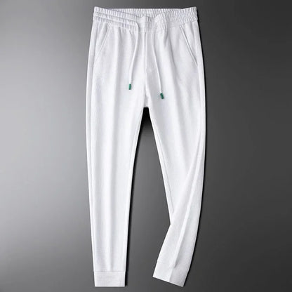 Versatile black unisex relaxed fit pants, ideal for everyday casual wear & loungewear. Modern, comfortable style.