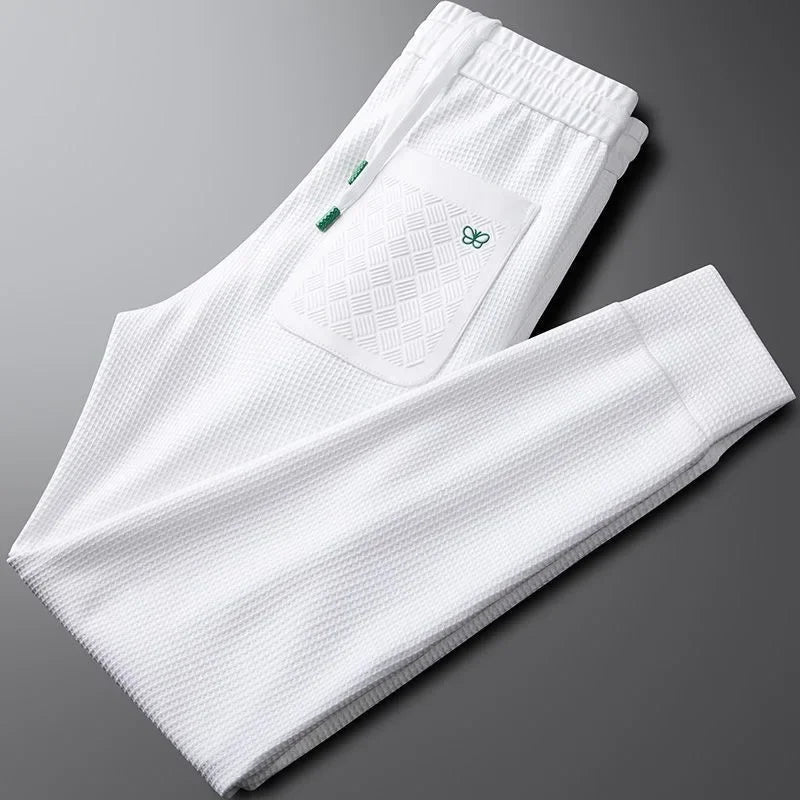 Easy care unisex relaxed fit pants in black, offering a comfortable modern fit for casual everyday style.