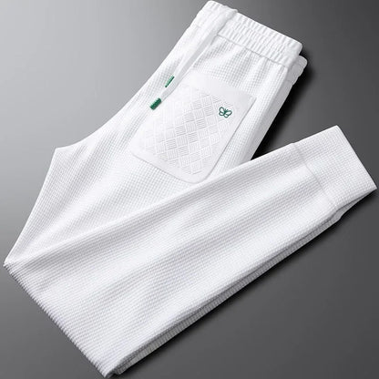 Easy care unisex relaxed fit pants in black, offering a comfortable modern fit for casual everyday style.