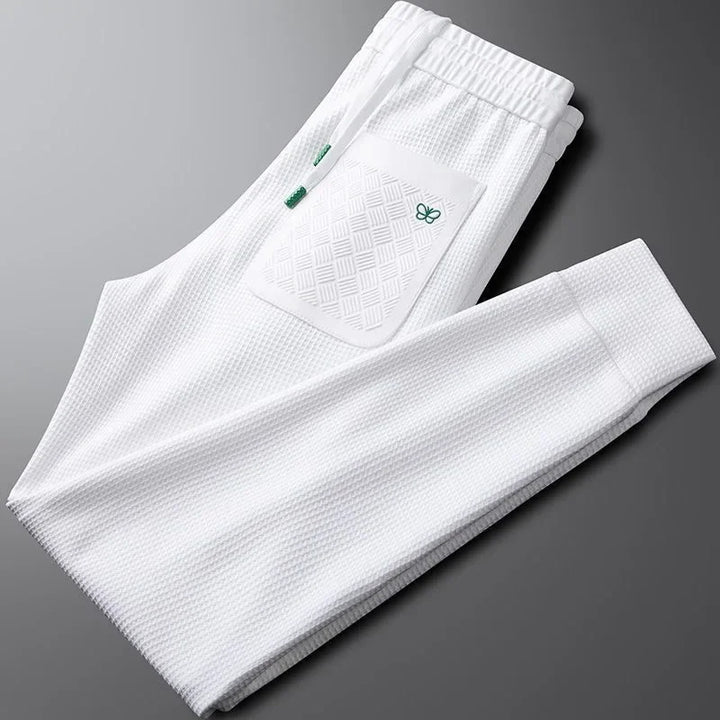Easy care unisex relaxed fit pants in black, offering a comfortable modern fit for casual everyday style.