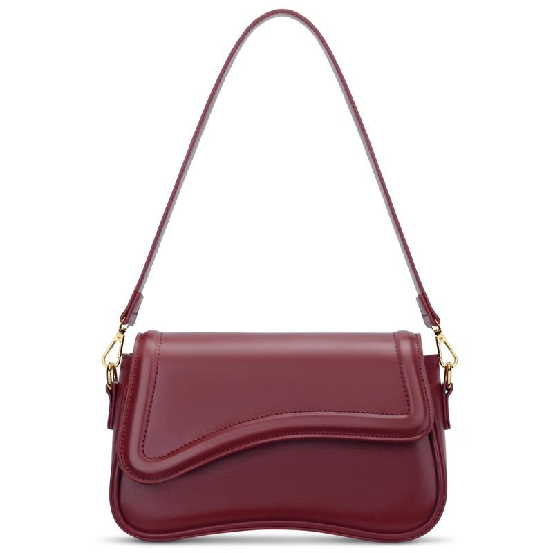 Elegant burgundy women's shoulder bag by Ravello, crafted from vegan leather with a stylish curved flap design.