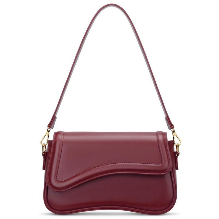 Elegant burgundy women's shoulder bag by Ravello, crafted from vegan leather with a stylish curved flap design.