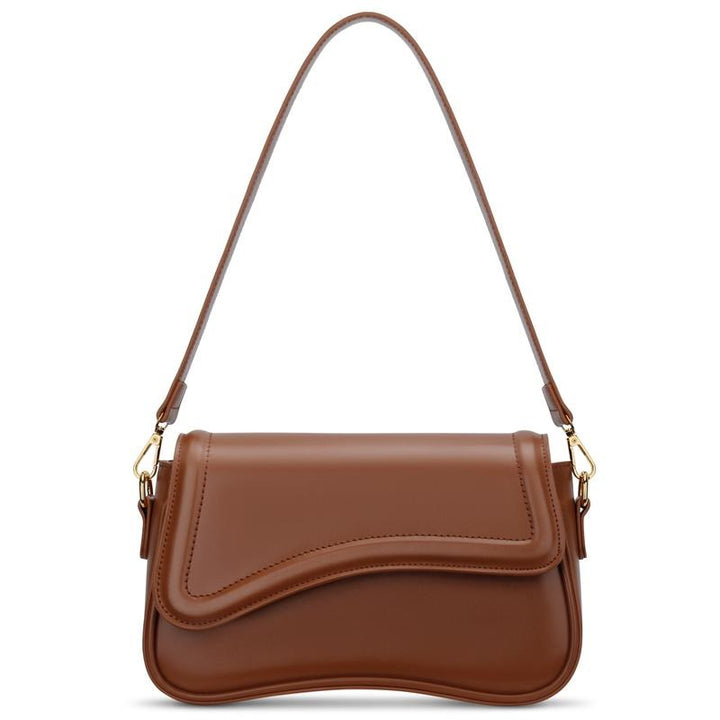 Chic black vegan leather women's shoulder bag, the Ravello features a unique curved flap for elegant style.