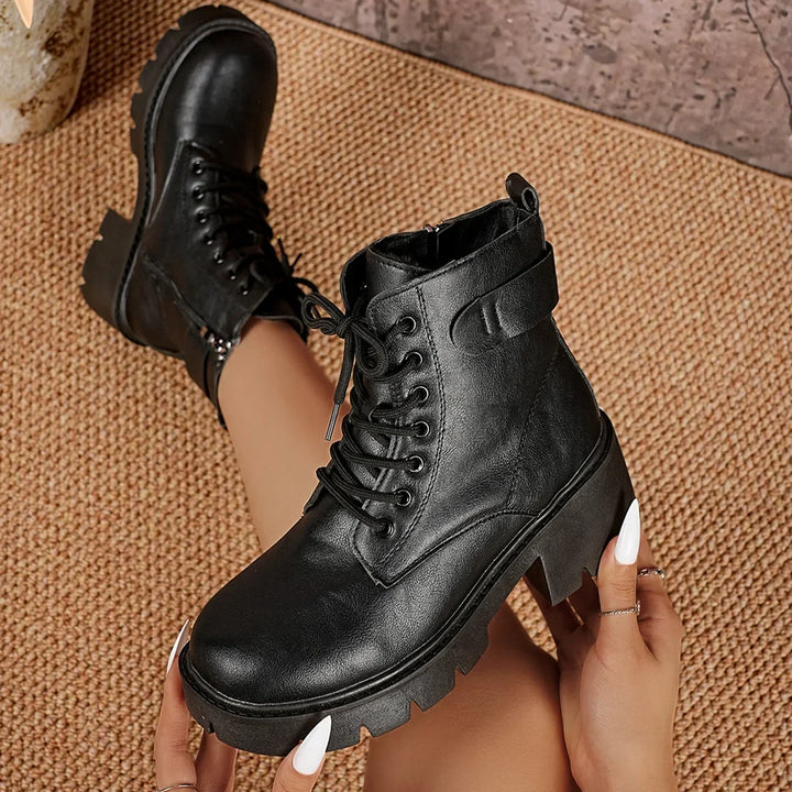 Statement black women's lace-up platform ankle boots with chunky lug sole, adding an edgy touch to any outfit.