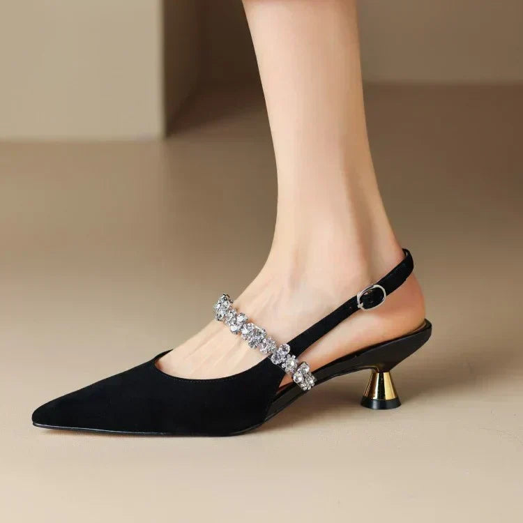 Women's black pointed toe slingback heels with elegant crystal strap. Ideal for formal and party events.