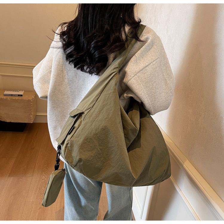 Black women's spacious crossbody bag with organizer pocket, perfect for everyday use.