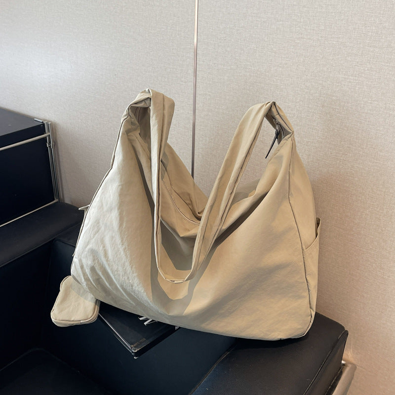 Stylish green large capacity shoulder bag for women, featuring a practical organizer pocket.