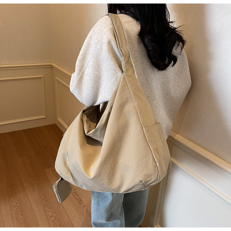 Navy blue spacious women's everyday bag, a stylish handbag with an organizer pocket.