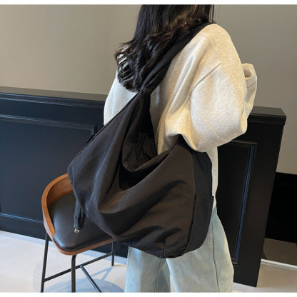 Women's black shoulder bag with organizer pocket, a spacious and stylish everyday accessory.