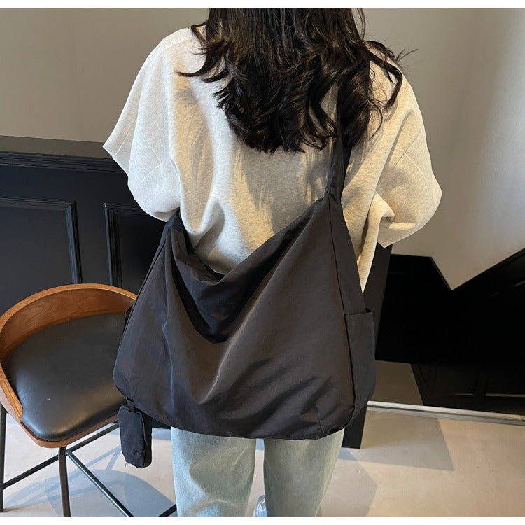 Green versatile crossbody bag for women, offering large capacity and a handy organizer.
