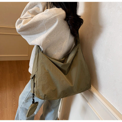 Coffee spacious women's travel accessory, a stylish crossbody bag with an organizer pocket.