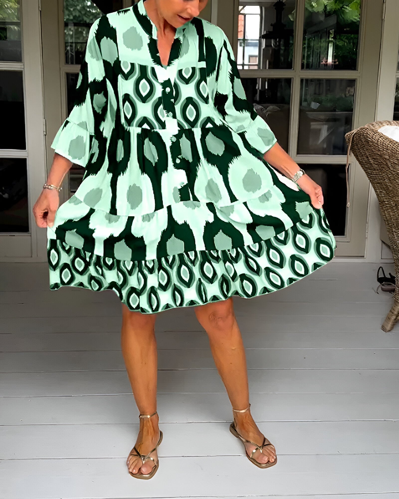 Casual women's bohemian maxi dress featuring a vibrant geometric print, tiered design, and stylish ruffle cuffs.