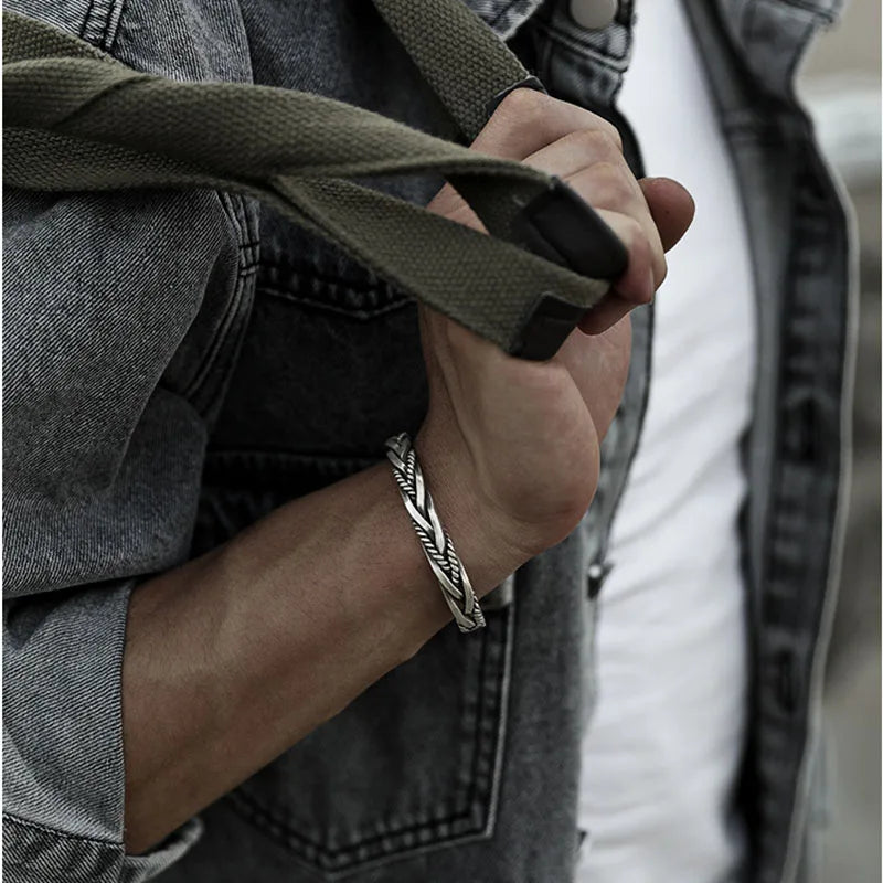 Close-up of a bold men's twisted sterling silver cuff bracelet, ideal for daily wear.
