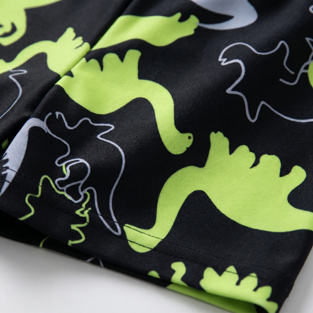 Stylish boys' 2-piece dinosaur swim set. Long sleeve rash guard and coordinating shorts for summer activewear.
