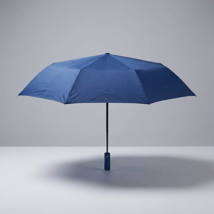 Portable BrollyMate compact travel umbrella, windproof design for easy rain protection on the go.