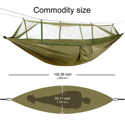 Backpacking camping hammock unfurled, showcasing its protective mosquito net and rainfly.