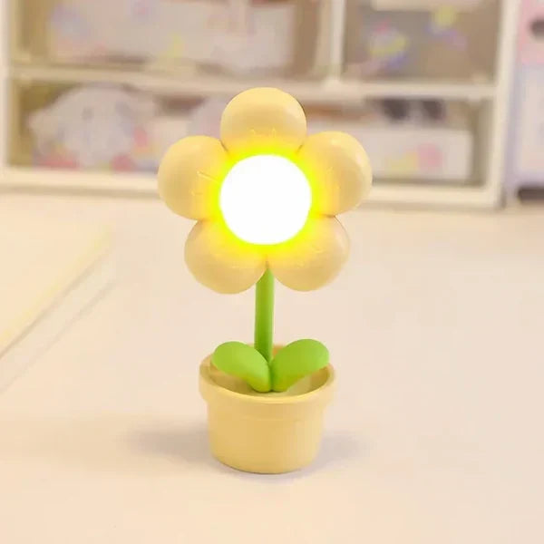 Small LED flower table lamp, BlossomGlow, provides relaxing ambient lighting for bedroom decor.