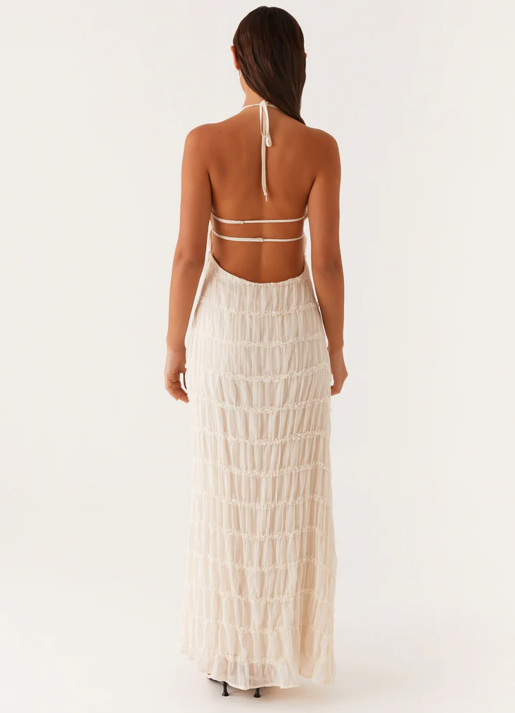 Women's halter maxi dress for wedding guests, elegant and modern style.
