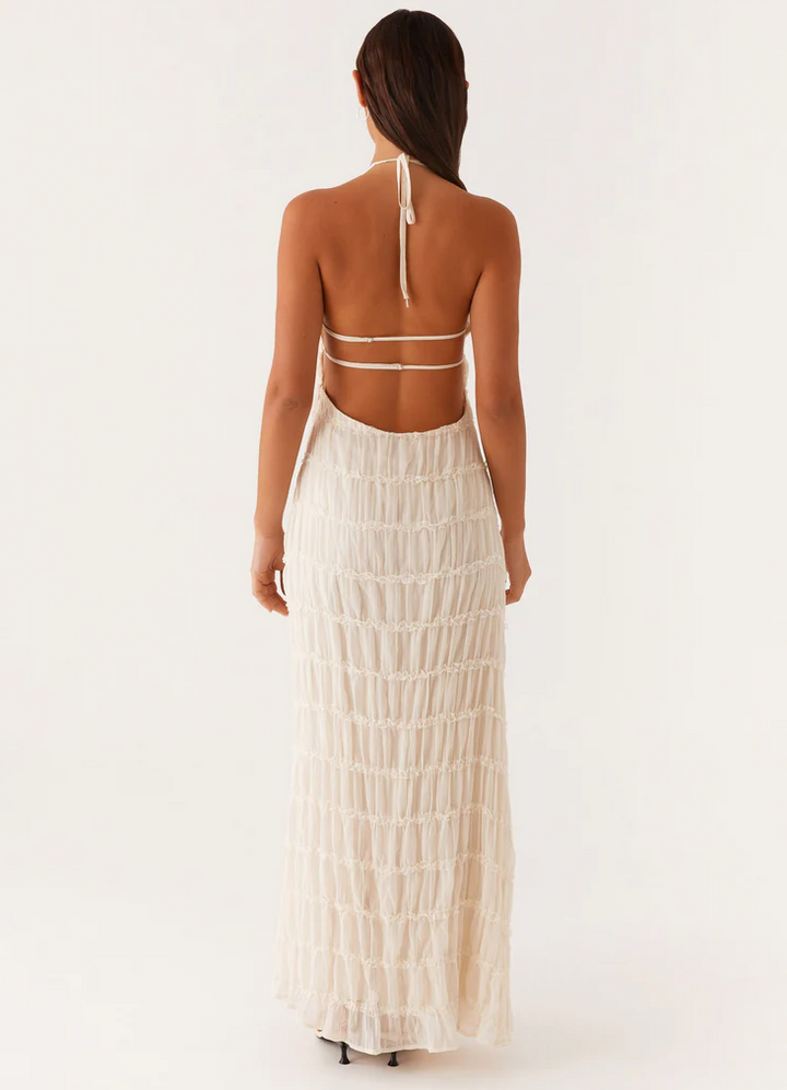 Women's halter maxi dress for wedding guests, elegant and modern style.