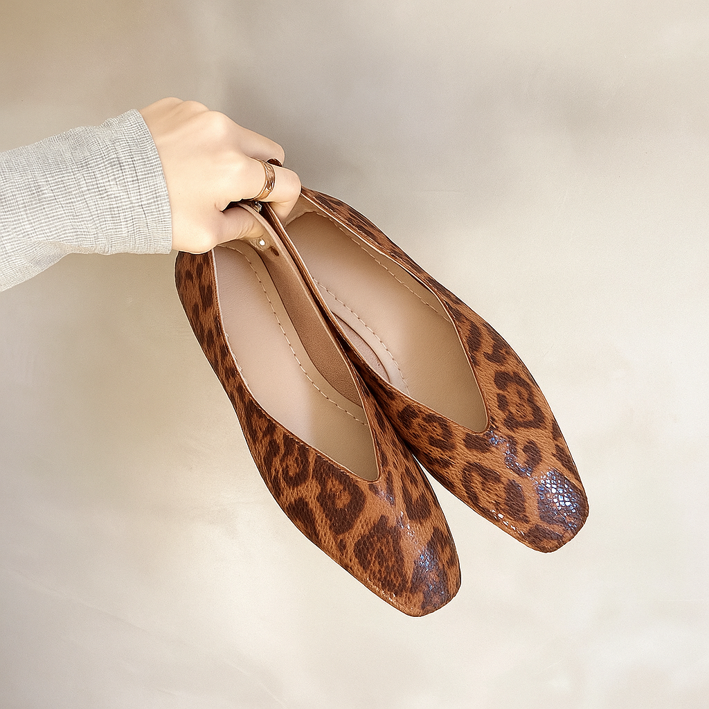 Stylish animal print flats for women, elegant leopard pattern, comfortable slip-on design.
