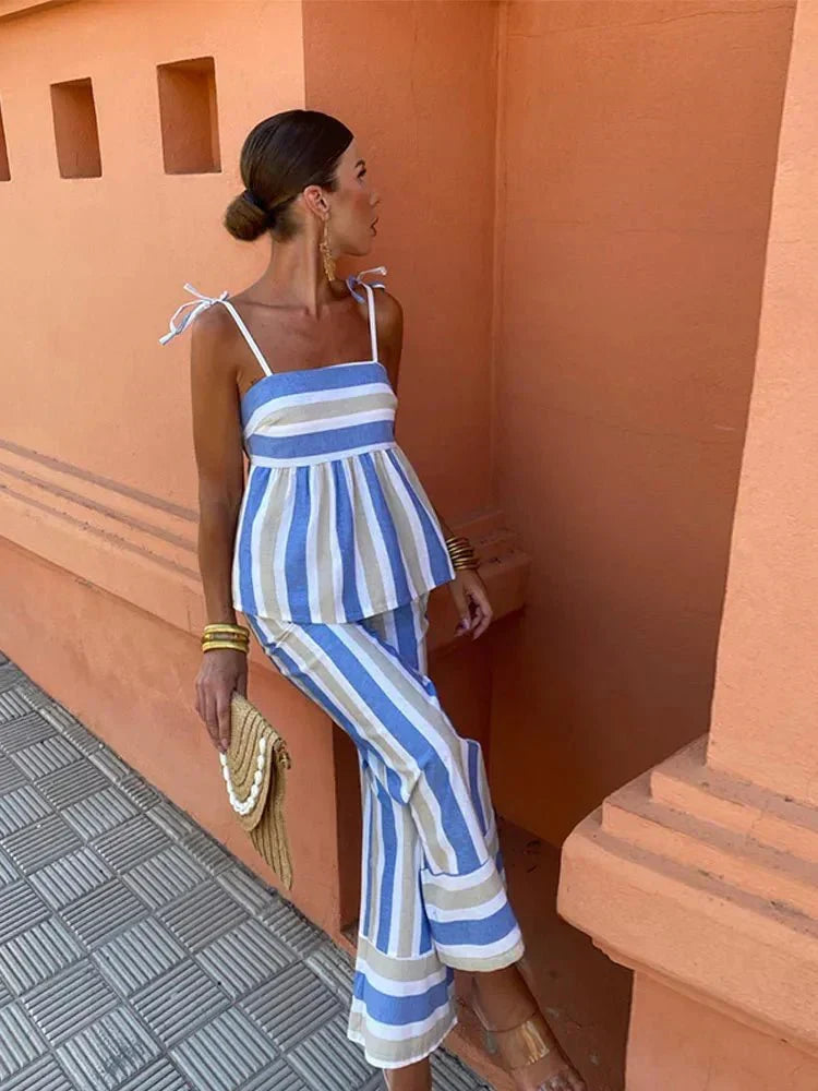 Women's two-piece striped peplum top & wide leg pants set. Fashionable and comfortable for a summer wedding guest.