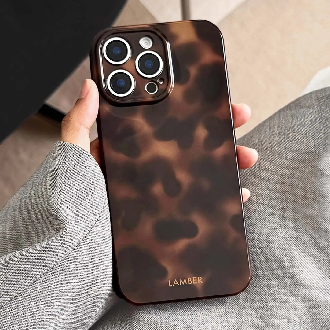 Durable tortoiseshell glass iPhone case, scratch-resistant TPU phone cover with elegant design.