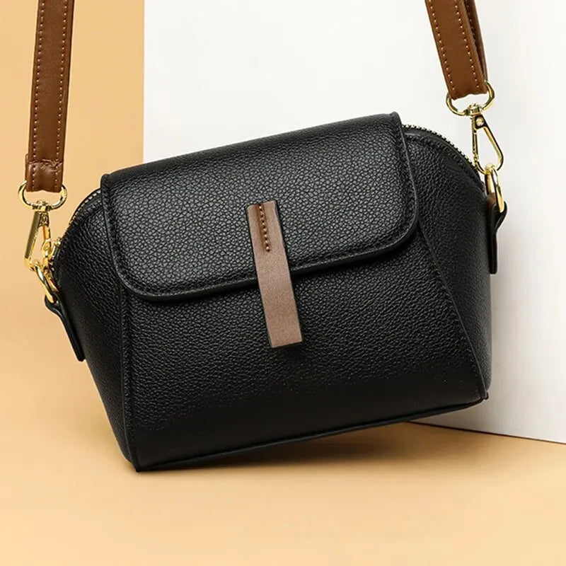 Elegant women's vegan leather small crossbody bag with adjustable strap.