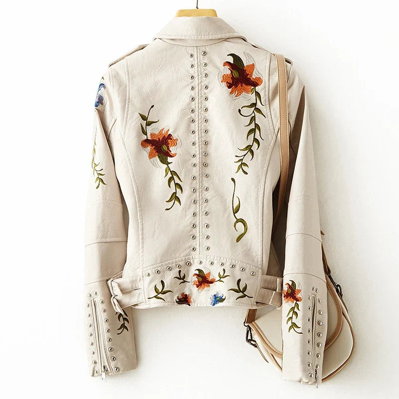 Edgy black women's moto jacket, a modern biker style statement piece. Chic fashion outerwear for everyday wear.
