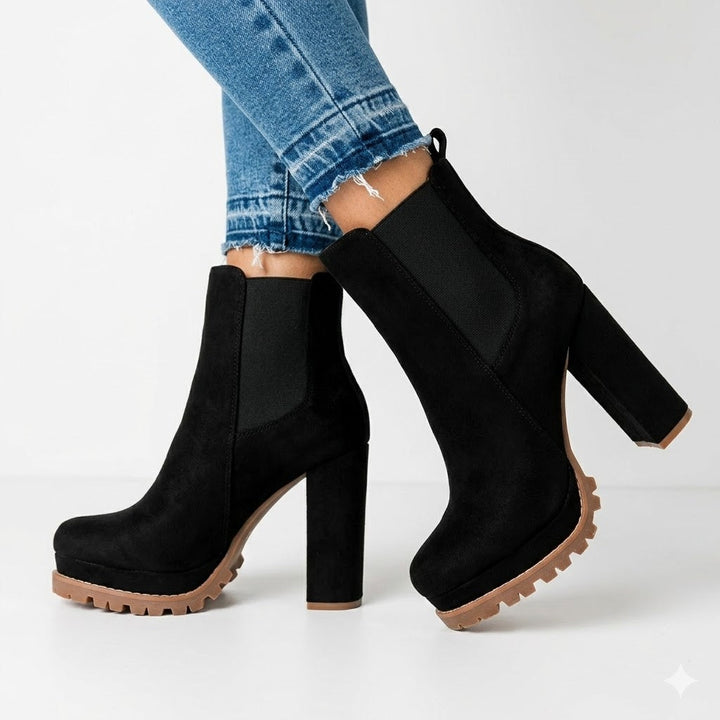 Chic women's black slip-on ankle boots with a trendy platform and sturdy block heel, perfect for fashion.