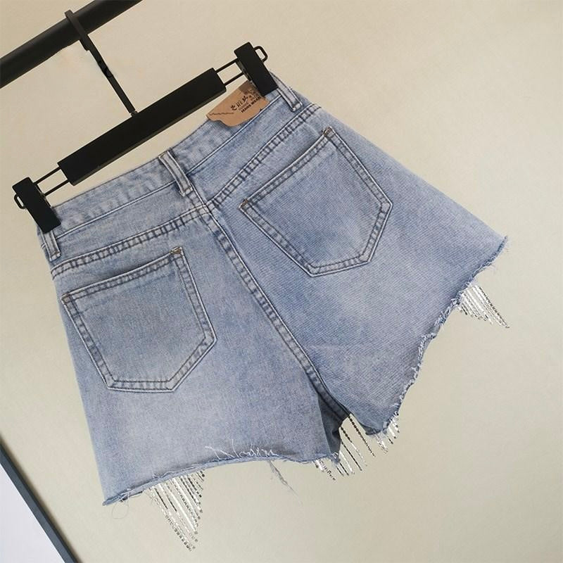 Fashionable women's blue tassel shorts, offering chic style and comfort for diverse summer looks. Casual yet elegant.