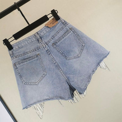 Fashionable women's blue tassel shorts, offering chic style and comfort for diverse summer looks. Casual yet elegant.