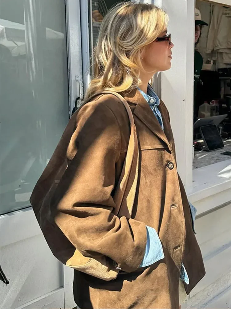 Versatile women's longline brown jacket. A chic layering piece for fall & spring, enhancing any everyday outfit.
