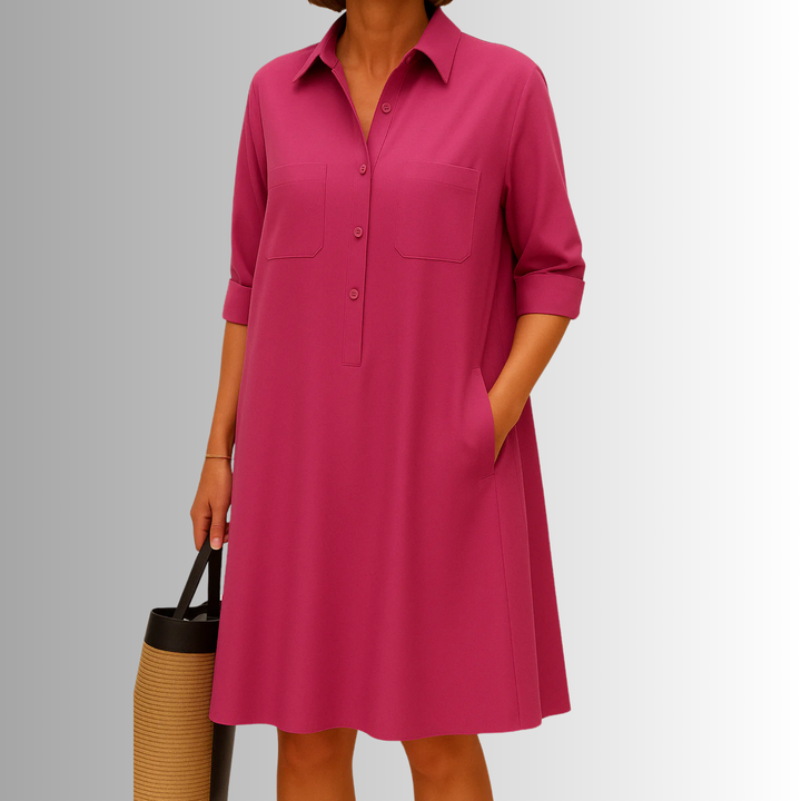 Close-up of the button-front detail on a women's A-line dress. Highlighting functional buttons and chest pockets.