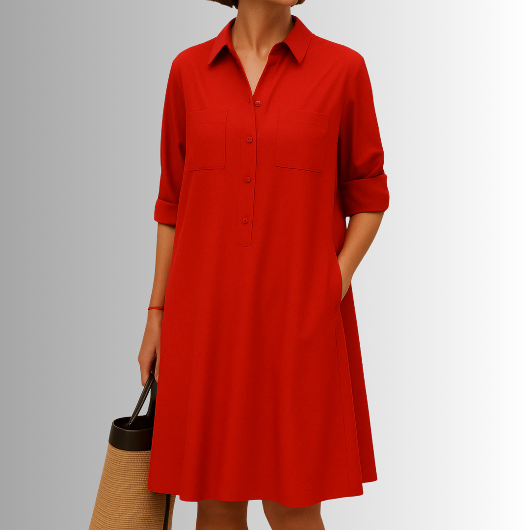 Full shot of a black button-front A-line dress. This women's dress features a flattering silhouette and practical pockets.