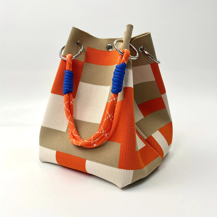Women's patchwork canvas mini bucket bag with stripes, a chic shoulder or crossbody accessory for modern style.
