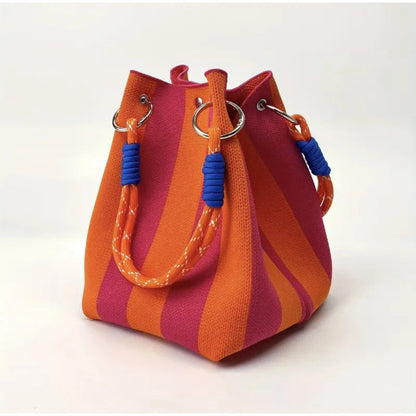 Stylish striped canvas mini bucket bag for women, a chic shoulder or crossbody accessory for modern fashion.