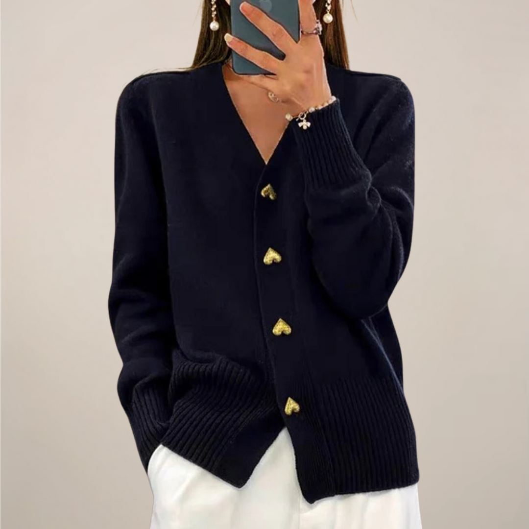 Chic women's cardigan with unique gold heart buttons. Elegant and versatile long sleeve sweater for day to night wear.