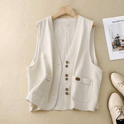 Chic women's cotton-linen vest with button front & pockets, perfect for spring/summer layering. Versatile fashion.