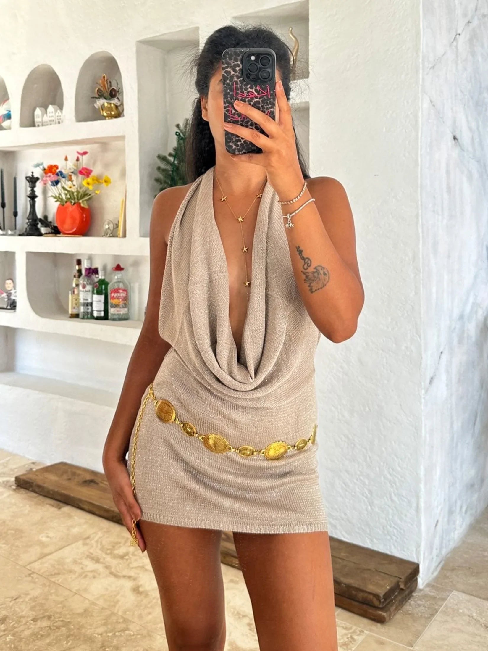 Sleeveless backless mini dress for women with a deep V-neck, offering a flirty and chic look for parties.