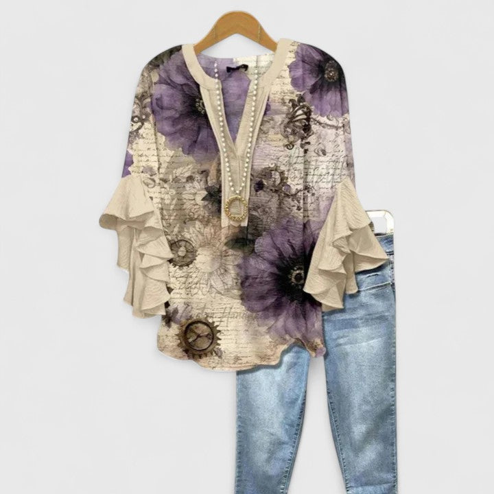 Classic women's floral print blouse with graceful ruffled sleeves, an essential for your wardrobe.