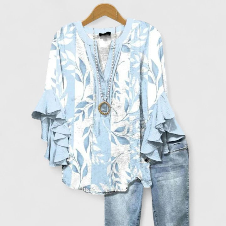 Feminine women's blouse with a beautiful floral print and charming ruffled sleeves for a chic style.