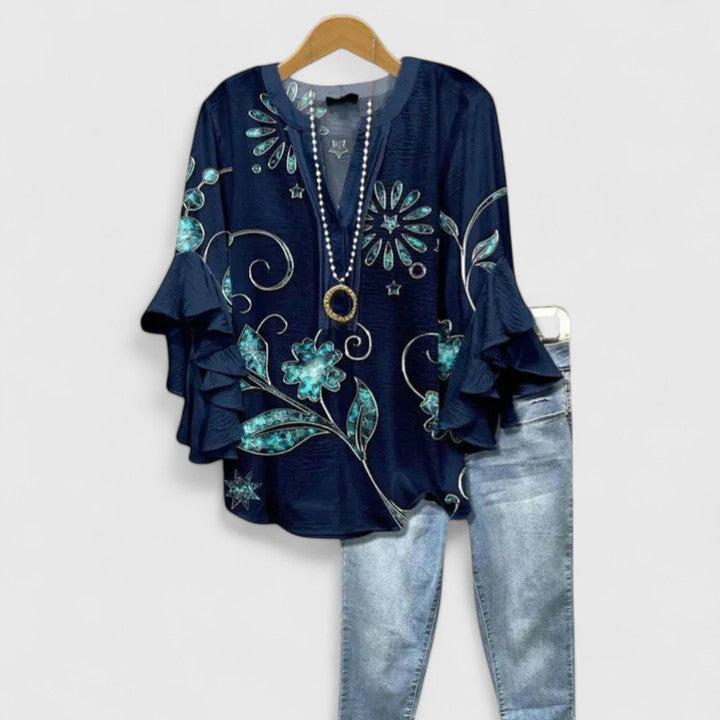 Trendy ladies' floral blouse with playful ruffled sleeves, offering a chic and comfortable fit.