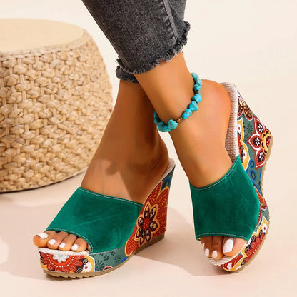 Stylish women's wedge sandals featuring vibrant floral patterns. Perfect comfortable slip-on mules for fashion.