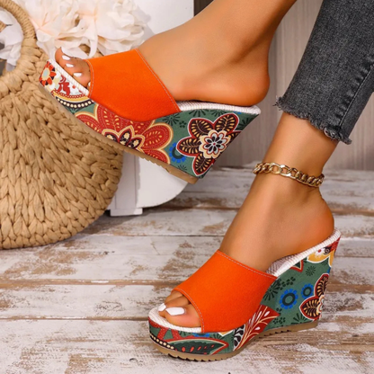 Vibrant floral wedge sandals for women. Comfortable slip-on mules for a chic and fashionable summer style.