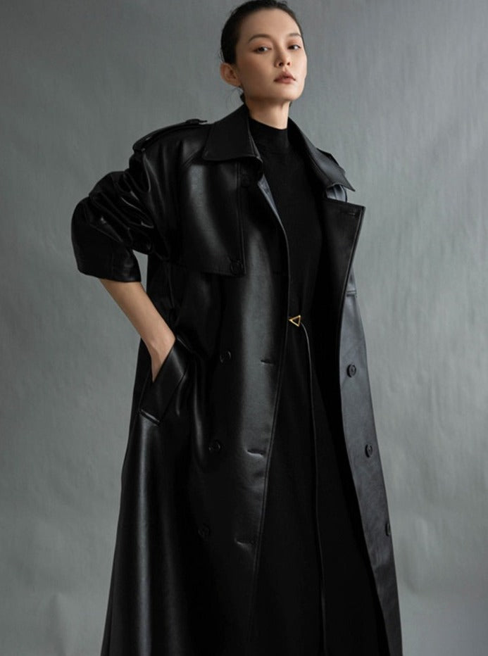 Stylish women's long trench coat with sophisticated belt detail, ideal for versatile fashion looks.