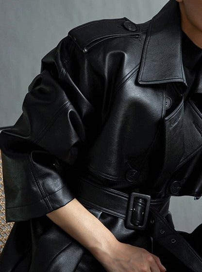 Fashionable women's long trench coat, featuring classic lapels and a versatile design element.