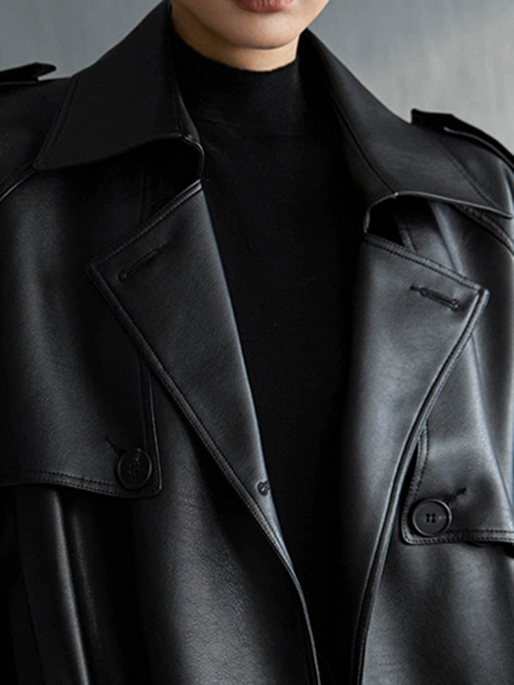 Full length view of a women's chic long trench coat, adding elegance to any spring outfit.