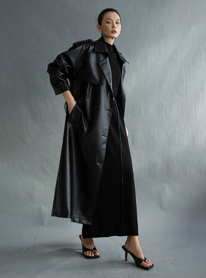 Stylish women's long trench coat, perfect for layering during transitional fall and spring weather.