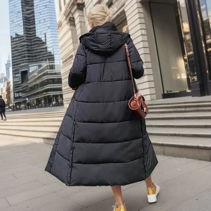 Back view of an elegant women's long coat, perfect for cold weather fashion.